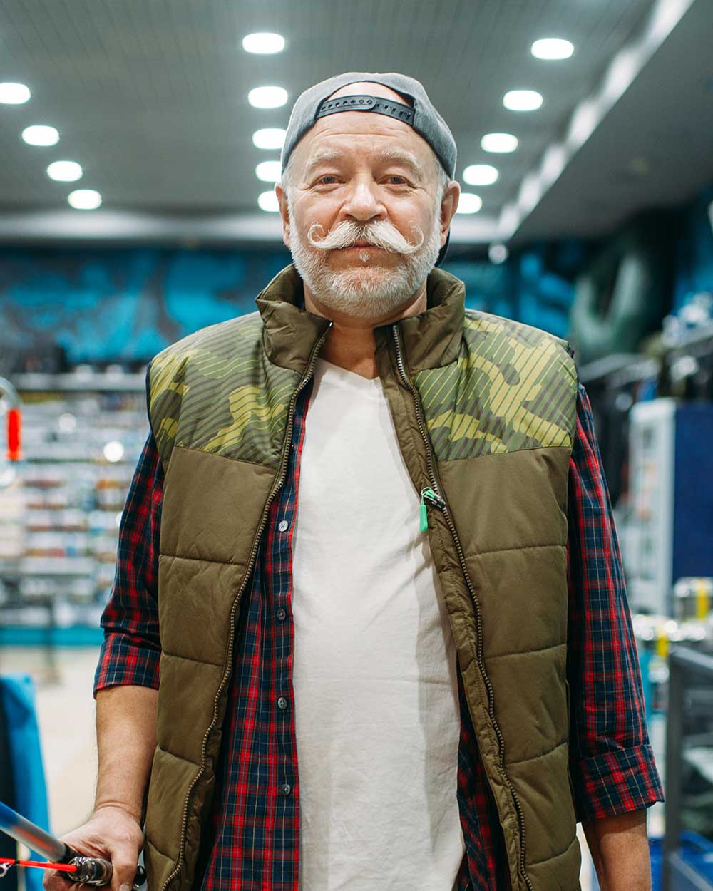 fisherman with rod and bucket in fishing shop 3829ZEX